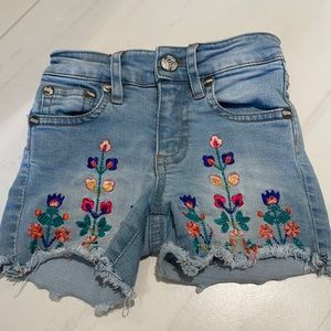 LIKE NEW PEEK GIRLS ADJUSTABLE JEAN SHORTS WITH FLOWER DETAIL
